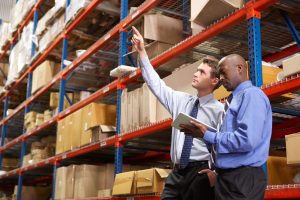 two men reviewing inventory in a warehouse