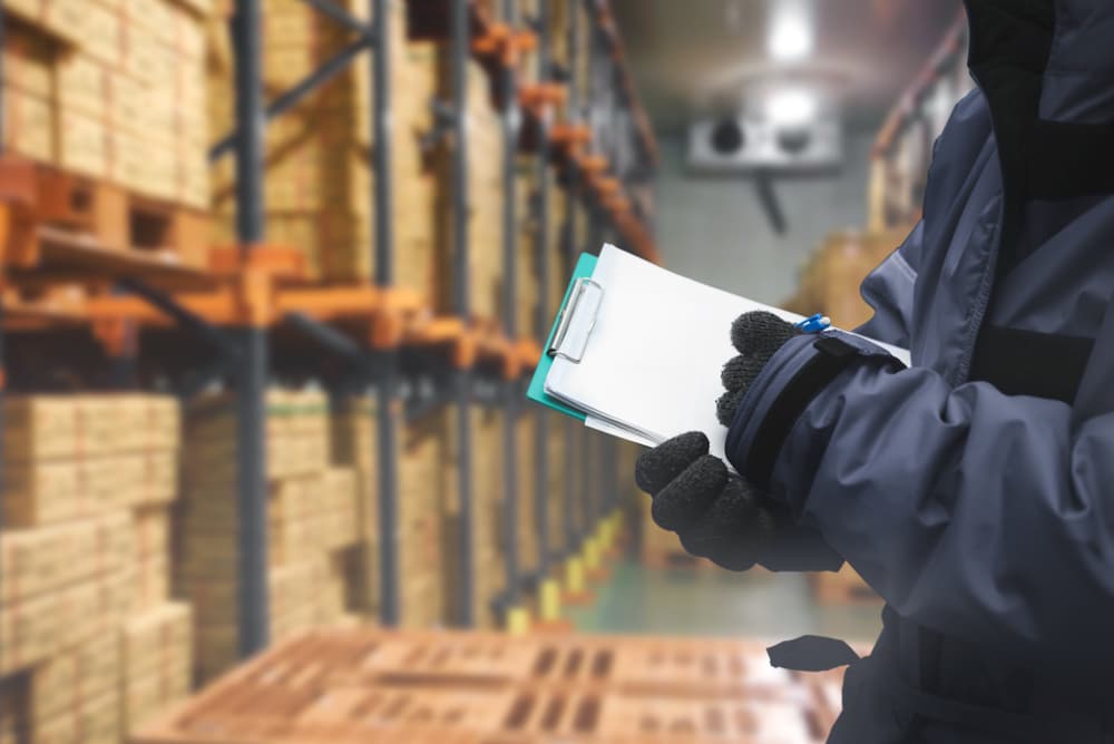 cold storage warehouse worker writing